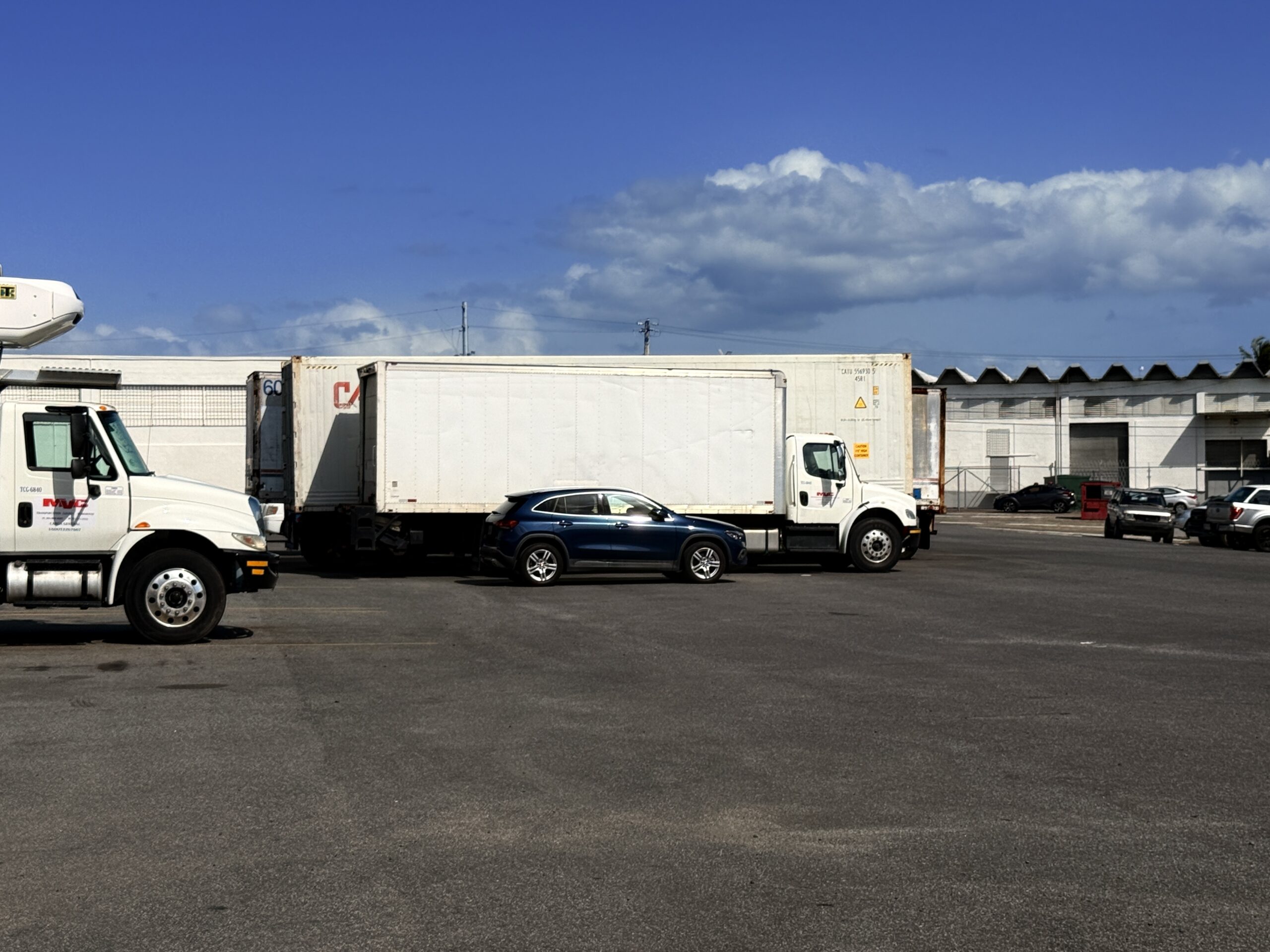 SJU Logistics box trucks, refrigerated truck and containers staged at the Carolina, Puerto Rico freight yard