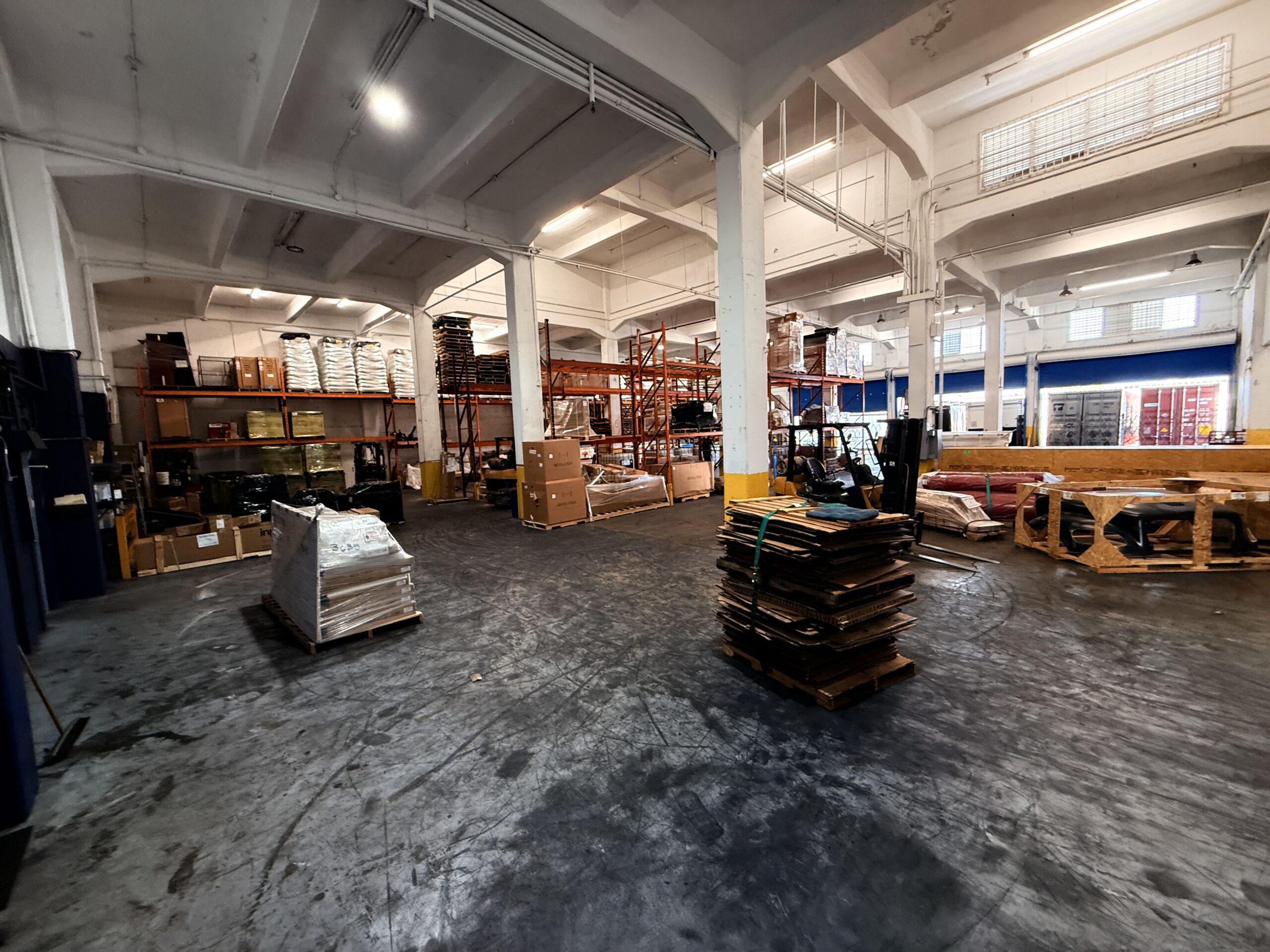 Dry warehousing floor with pallet racking and staged freight at SJU Logistics in Carolina, Puerto Rico